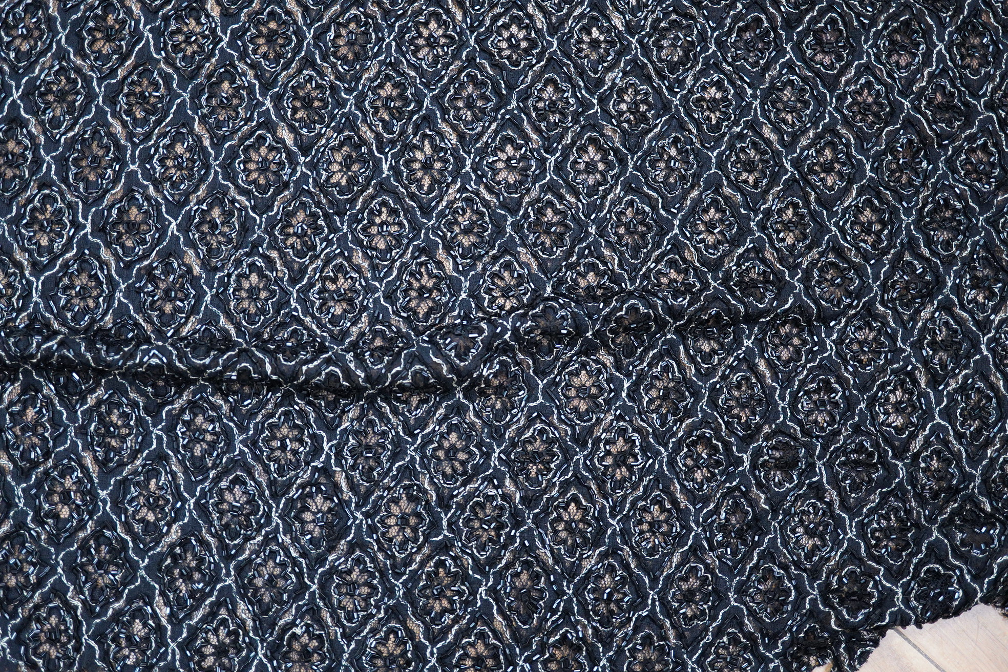A length of silk velvet flocked taffeta, a purple silk panel, a mid century beaded length and two lengths of late 20th century braiding